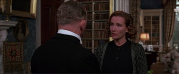 Movie still from “The Remains of the Day” (1993), directed by James Ivory – A woman in a black dress talking to a man in a black suit; Close Up shot, Over the shoulder angle