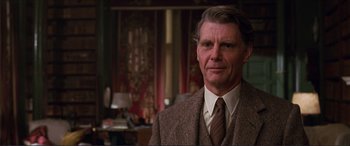 Movie still from “The Remains of the Day” (1993), directed by James Ivory – A person wearing a suit and tie; Close Up shot, Low angle