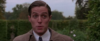 Movie still from “The Remains of the Day” (1993), directed by James Ivory – A person wearing a suit and tie; Close Up shot, Low angle