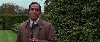 Movie still from “The Remains of the Day” (1993), directed by James Ivory – A man wearing a brown jacket and a tie; Medium shot, Over the shoulder angle