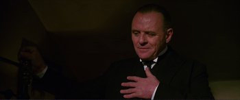 Movie still from “The Remains of the Day” (1993), directed by James Ivory – A man in a black suit and a white tie; Close Up shot, Low angle