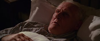 Movie still from “The Remains of the Day” (1993), directed by James Ivory – An older man laying in a bed with his eyes wide open; Close Up shot, High angle