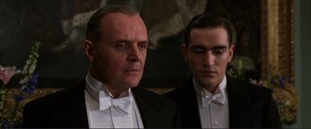 Movie still from “The Remains of the Day” (1993), directed by James Ivory – Two men in tuxedos are standing next to each other; Close Up shot, Low angle