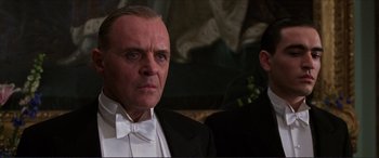 Movie still from “The Remains of the Day” (1993), directed by James Ivory – A person wearing a suit and tie; Close Up shot, Low angle