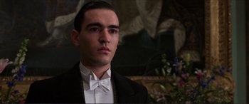 Movie still from “The Remains of the Day” (1993), directed by James Ivory – A man in a suit and bow tie; Close Up shot, Low angle