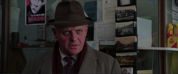 Movie still from “The Remains of the Day” (1993), directed by James Ivory – An older man wearing a hat and a coat; Close Up shot, Over the shoulder angle