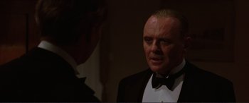 Movie still from “The Remains of the Day” (1993), directed by James Ivory – A person wearing a suit and tie; Close Up shot, Over the shoulder angle