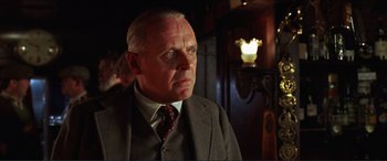 Movie still from “The Remains of the Day” (1993), directed by James Ivory – An older man wearing a suit and a tie; Close Up shot, Low angle