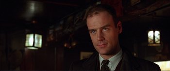 Movie still from “The Remains of the Day” (1993), directed by James Ivory – A person wearing a suit and tie; Close Up shot, Low angle