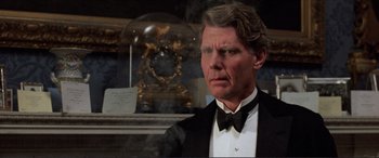 Movie still from “The Remains of the Day” (1993), directed by James Ivory – An older man in a tuxedo and a bow tie; Close Up shot, Over the shoulder angle