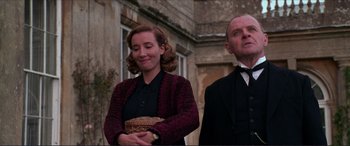 Movie still from “The Remains of the Day” (1993), directed by James Ivory – A man and a woman standing next to each other; Medium shot, Low angle