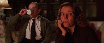 Movie still from “The Remains of the Day” (1993), directed by James Ivory – A man and a woman sitting next to each other; Medium shot, Low angle