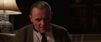 Movie still from “The Remains of the Day” (1993), directed by James Ivory – A person wearing a suit and tie; Close Up shot, Over the shoulder angle