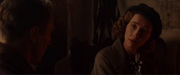 Movie still from “The Remains of the Day” (1993), directed by James Ivory – A man and a woman sitting on a couch; Close Up shot, Over the shoulder angle