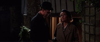 Movie still from “The Remains of the Day” (1993), directed by James Ivory – A man and a woman standing next to each other; Medium shot, Low angle