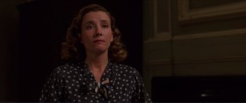 Movie still from “The Remains of the Day” (1993), directed by James Ivory – A woman in a black and white polka dot shirt; Close Up shot, Low angle