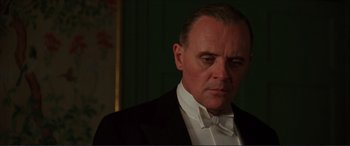 Movie still from “The Remains of the Day” (1993), directed by James Ivory – A person wearing a suit and tie; Close Up shot, Low angle