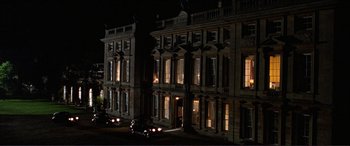 Movie still from “The Remains of the Day” (1993), directed by James Ivory – A building that has been lit up at night; Extreme Wide shot, High angle