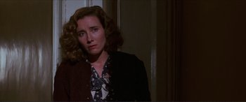 Movie still from “The Remains of the Day” (1993), directed by James Ivory – A woman in a black jacket and a black and white blouse; Close Up shot, Low angle