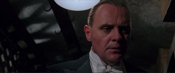 Movie still from “The Remains of the Day” (1993), directed by James Ivory – A person wearing a suit and tie; Close Up shot, Low angle