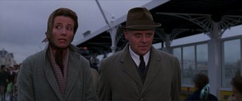 Movie still from “The Remains of the Day” (1993), directed by James Ivory – A man wearing a hat and a suit and tie; Medium shot, Low angle