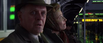 Movie still from “The Remains of the Day” (1993), directed by James Ivory – A man and a woman wearing hats and looking into the distance; Close Up shot, Low angle