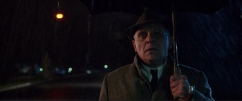 Movie still from “The Remains of the Day” (1993), directed by James Ivory – An older man wearing a hat and a coat; Close Up shot, Low angle