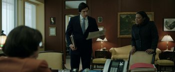 Movie still from “The Report” (2019), directed by Scott Z. Burns – A man in a suit and tie holding papers in his hands; Medium shot, Low angle