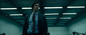 Movie still from “The Report” (2019), directed by Scott Z. Burns – A man in a suit and a tie; Medium shot, Low angle