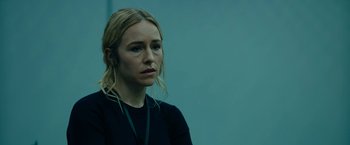 Movie still from “The Report” (2019), directed by Scott Z. Burns – A woman with blonde hair wearing a black shirt; Close Up shot, Over the shoulder angle