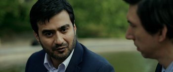 Movie still from “The Report” (2019), directed by Scott Z. Burns – A person wearing a suit and tie; Close Up shot, Over the shoulder angle