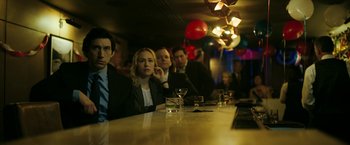 Movie still from “The Report” (2019), directed by Scott Z. Burns – A group of people sitting at a bar with drinks; Medium shot, High angle