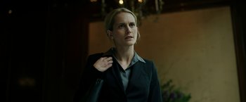 Movie still from “The Report” (2019), directed by Scott Z. Burns – A woman in a black jacket holding a black bag; Close Up shot, Low angle