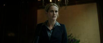 Movie still from “The Report” (2019), directed by Scott Z. Burns – A woman wearing a suit and looking to her left; Close Up shot, Low angle