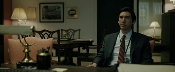 Movie still from “The Report” (2019), directed by Scott Z. Burns – A man and woman sitting at a table in a room; Medium shot, Over the shoulder angle