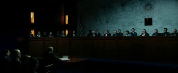 Movie still from “The Report” (2019), directed by Scott Z. Burns – A group of people sitting in a room; Extreme Wide shot, High angle