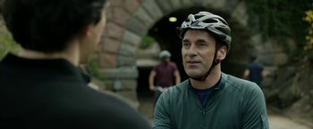 Movie still from “The Report” (2019), directed by Scott Z. Burns – A man wearing a bicycle helmet talking to another man; Close Up shot, Over the shoulder angle