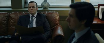 Movie still from “The Report” (2019), directed by Scott Z. Burns – Two men in suits sitting in front of a laptop; Medium shot, Over the shoulder angle