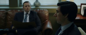 Movie still from “The Report” (2019), directed by Scott Z. Burns – Two men in suits are sitting in a chair; Close Up shot, Over the shoulder angle