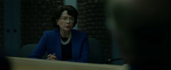 Movie still from “The Report” (2019), directed by Scott Z. Burns – An older woman sitting at a table in front of a mirror; Close Up shot, Over the shoulder angle