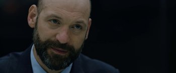 Movie still from “The Report” (2019), directed by Scott Z. Burns – A man with a bald head and a beard; Close Up shot, Low angle