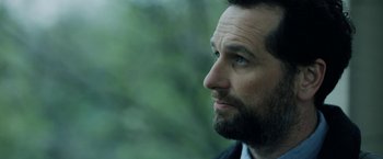 Movie still from “The Report” (2019), directed by Scott Z. Burns – A person with a beard; Close Up shot, Over the shoulder angle