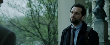 Movie still from “The Report” (2019), directed by Scott Z. Burns – A person wearing a suit and tie; Close Up shot, Over the shoulder angle