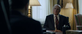 Movie still from “The Report” (2019), directed by Scott Z. Burns – A man sitting at a table in front of another man; Medium shot, Over the shoulder angle