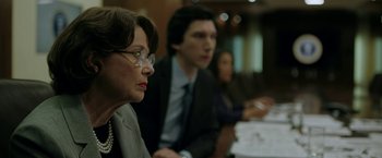 Movie still from “The Report” (2019), directed by Scott Z. Burns – A woman and two men sitting at a conference table; Close Up shot, Over the shoulder angle