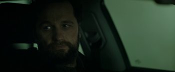 Movie still from “The Report” (2019), directed by Scott Z. Burns – A man with a goatee and a beard in a car; Close Up shot, Over the shoulder angle