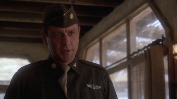 Movie still from “The Right Stuff” (1983), directed by Philip Kaufman – A man in a military uniform standing in front of a window; Close Up shot, Low angle