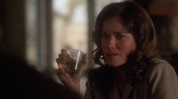 Movie still from “The Right Stuff” (1983), directed by Philip Kaufman – A woman is holding a glass in her hand; Close Up shot, Over the shoulder angle