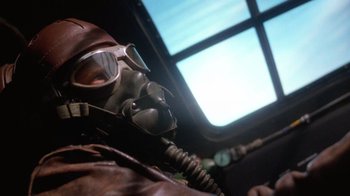 Movie still from “The Right Stuff” (1983), directed by Philip Kaufman – A person wearing a gas mask in a plane cockpit; Close Up shot, Low angle