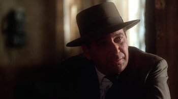 Movie still from “The Right Stuff” (1983), directed by Philip Kaufman – A person wearing a suit and a hat; Close Up shot, Low angle